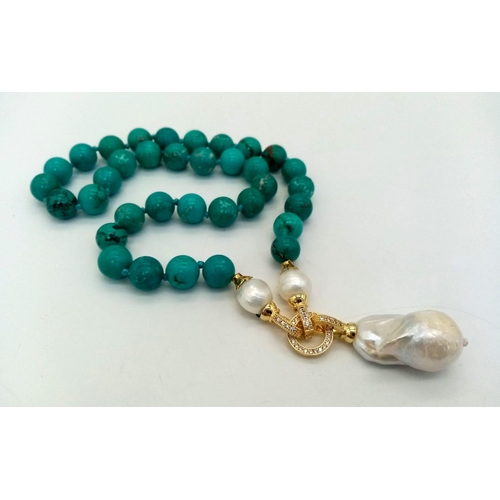 291 - An Exquisite Blue Turquoise and Baroque Pearl Necklace. 10mm turquoise beads lead to a Baroque Drop!... 