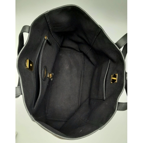 122 - A Black Leather Mulberry Handbag. Textured black leather exterior. Soft textile interior with zipped... 