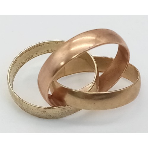 106 - A 9 K yellow and rose gold triple band ring, size: J, weight: 5 g.