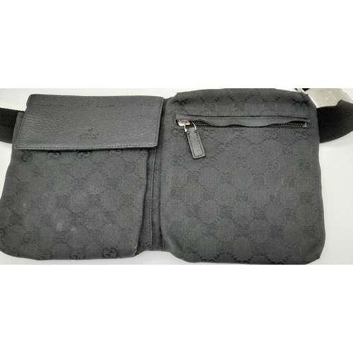 143 - A Gucci Belt (fanny pack) Bag. Black monogram canvas and leather exterior. Three pockets - two zippe... 