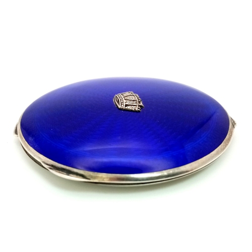 1689 - A vintage blue enamel circular compact. Total weight 98.11G. Diameter approx 8cm.