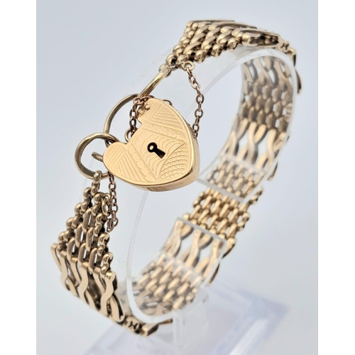 18 - A Beautifully Constructed 9K Yellow Gold Gate Bracelet with Heart Clasp. 18cm. 28.06g weight.