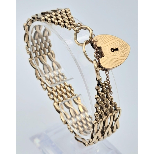 18 - A Beautifully Constructed 9K Yellow Gold Gate Bracelet with Heart Clasp. 18cm. 28.06g weight.