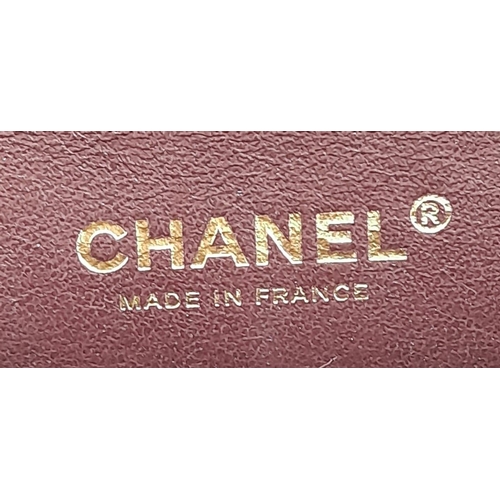 16 - A Classic Chanel Double Flap Bag. Quilted lambskin black leather exterior with gilded Chanel logo cl... 