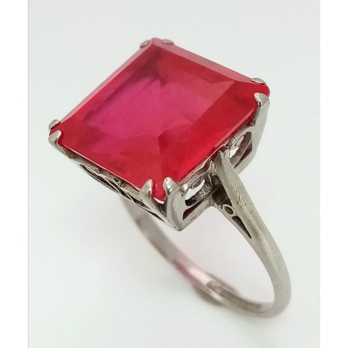 132 - A high quality ruby platinum ring, with a large (6.3 carats (appr), square, step cut, pigeon blood r... 