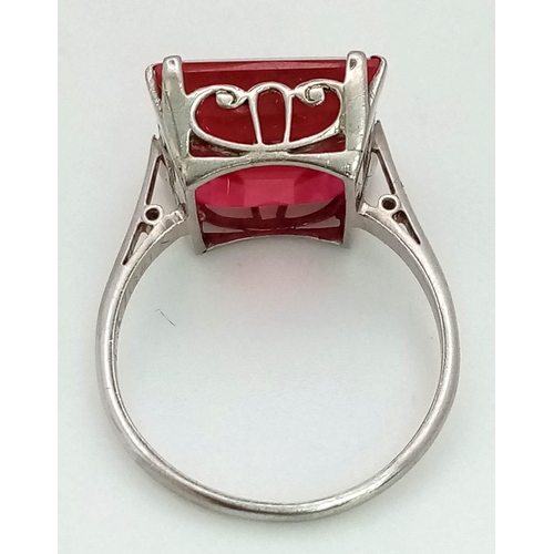 132 - A high quality ruby platinum ring, with a large (6.3 carats (appr), square, step cut, pigeon blood r... 