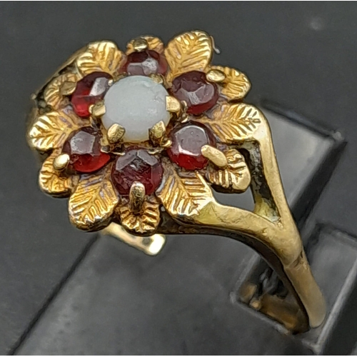 15 - A Vintage 9K Yellow Gold Garnet and Pearl Ring. Central pearl with a halo of garnets. Size N. 2.27g ... 