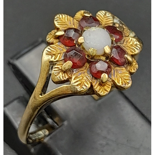 15 - A Vintage 9K Yellow Gold Garnet and Pearl Ring. Central pearl with a halo of garnets. Size N. 2.27g ... 