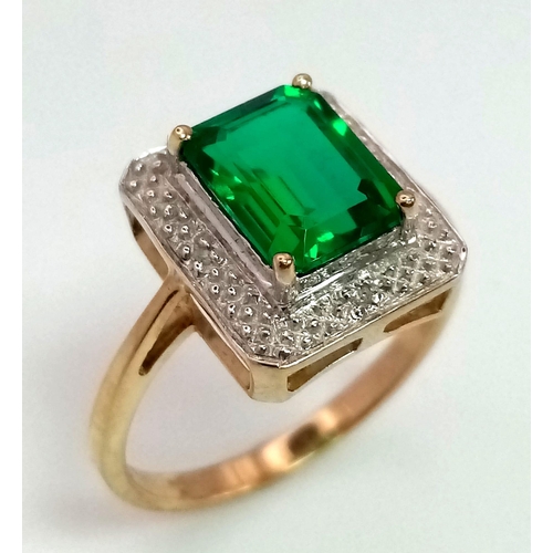 167 - A 9 K yellow and white gold ring with an emerald cut synthetic, flawless emerald. Fully British hall... 