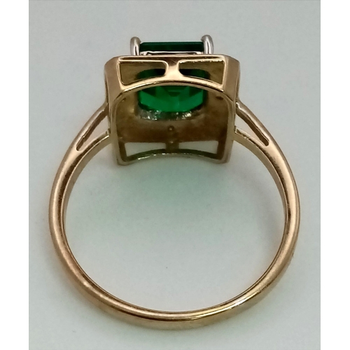 167 - A 9 K yellow and white gold ring with an emerald cut synthetic, flawless emerald. Fully British hall... 