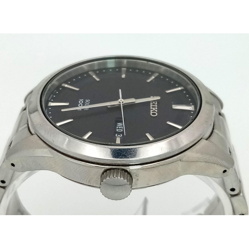 188 - A gents SEIKO, solar powered, dress watch, 42 mm case, black dial with date/day window, “Hardlex” gl... 