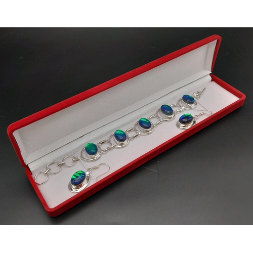 216 - A sterling silver bracelet and earrings set with opal-like cabochons, in a high quality, red velvet ... 