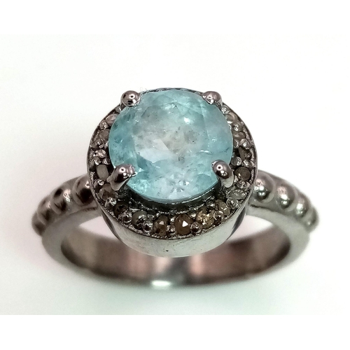 247 - A Blue Topaz Ring with a Rose cut Diamond Halo. Set in 925 Sterling Silver. 1.50ct topaz.  Diamond- ... 