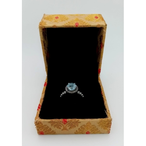 247 - A Blue Topaz Ring with a Rose cut Diamond Halo. Set in 925 Sterling Silver. 1.50ct topaz.  Diamond- ... 