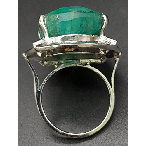 302 - A 50ct Brazilian Oval Cut Emerald Ring. Set in 925 Sterling Silver. Size P. Comes with a presentatio... 