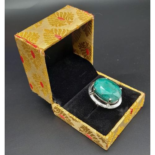 302 - A 50ct Brazilian Oval Cut Emerald Ring. Set in 925 Sterling Silver. Size P. Comes with a presentatio... 