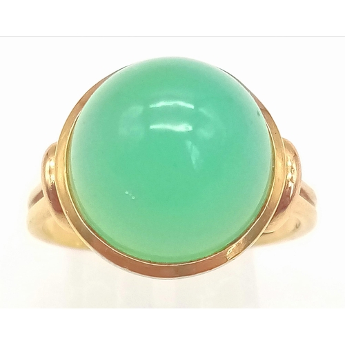 5 - An 18k Yellow Gold Green Jade Cabochon Ring. A mesmerising dome of luscious pale green jade. Size R/... 