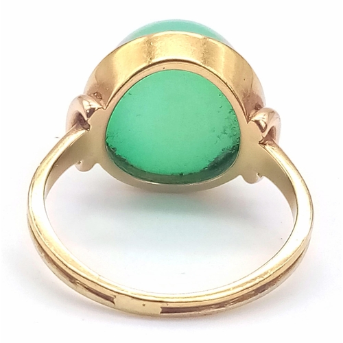 5 - An 18k Yellow Gold Green Jade Cabochon Ring. A mesmerising dome of luscious pale green jade. Size R/... 