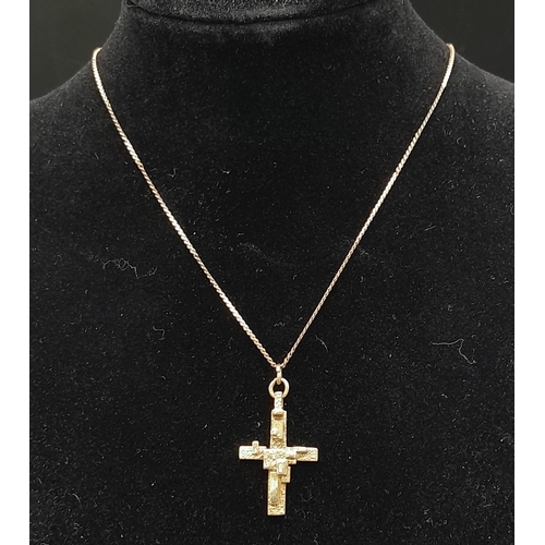 502 - An Abstract 9K Gold Crucifix Pendant on a 9K Yellow Gold Disappearing Necklace. 3cm and 48cm. 5g tot... 