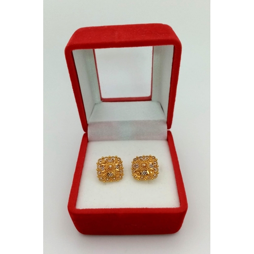 51 - A Pair of Asian Inspired 22k Yellow and White Gold Earrings.
3.4g total weight. Comes with fitted ca... 