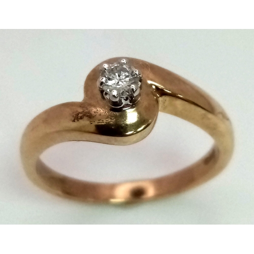 568 - A 9K Yellow Gold Diamond Crossover Solitaire Ring. Round cut diamond - 0.10ct. Size M. 3.1g total we... 