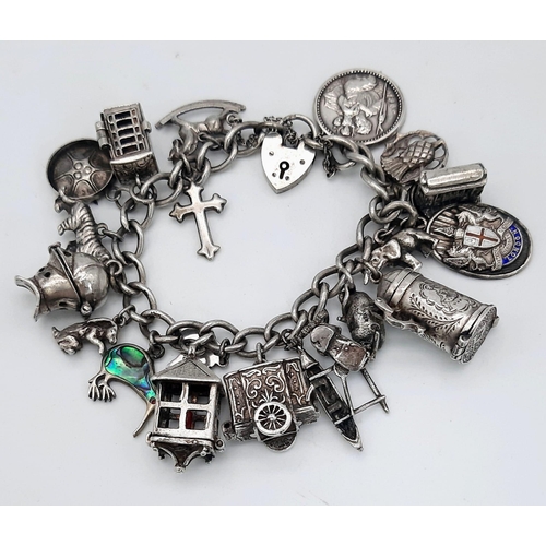 638 - A Vintage 925 Sterling Silver Charm Bracelet with Heart Clasp. Twenty charms including: Knight's hel... 