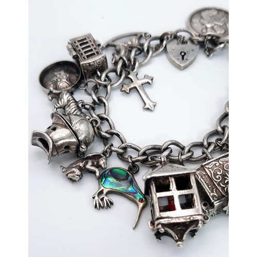 638 - A Vintage 925 Sterling Silver Charm Bracelet with Heart Clasp. Twenty charms including: Knight's hel... 