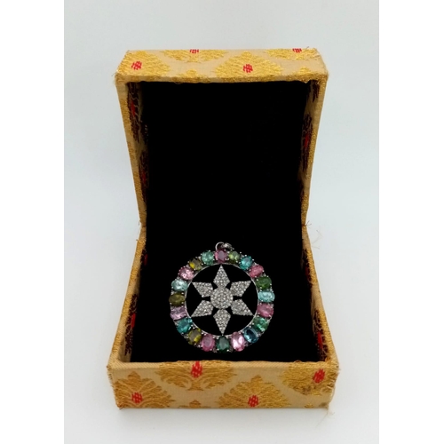 667 - A Multi-Coloured Tourmaline & Diamond Pendant. Central diamond encrusted star within a tourmaline ha... 