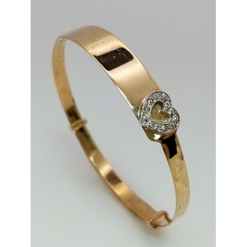 778 - A 9K Yellow Gold Childs White Stone Heart Expandable Bangle. 2.32g weight.