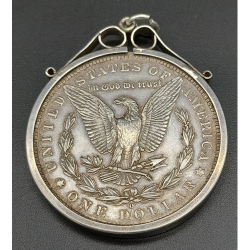 836 - AN 1884 SILVER DOLLARIN A SILVER PENDANT SETTING . 31.2gms   (GOOD DEFINITION FOR AGE)