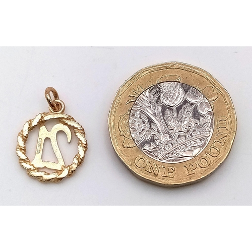 874 - A 9K Yellow Gold '21' Pendant. 18mm. 1g weight.