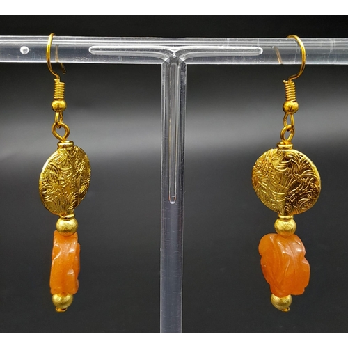 202 - An elegant and sophisticated, carved carnelian and vermeil necklace and earrings set . Necklace leng... 