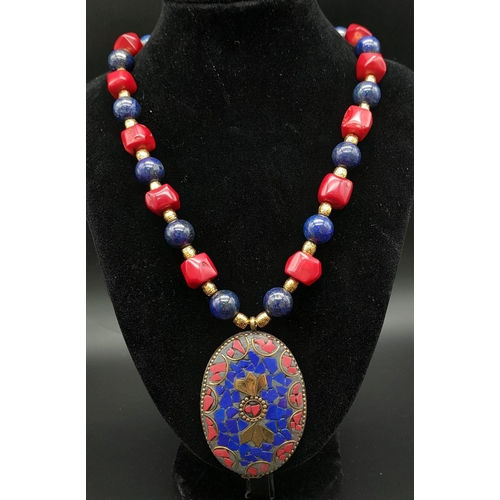 237 - A fashionable, Nepalese, ethnic, necklace and earrings set with lapis lazuli and red coral. Necklace... 