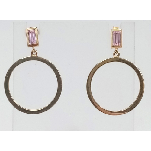 393 - A Pair of 9K Yellow Gold and Pink Topaz Hoop Earrings. Baguette cut topaz leads to a classic hoop. 5... 