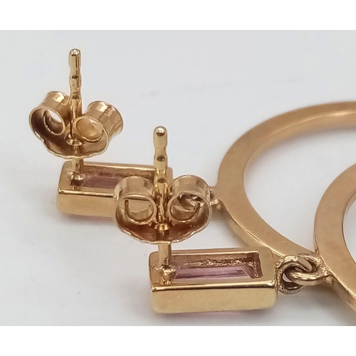 393 - A Pair of 9K Yellow Gold and Pink Topaz Hoop Earrings. Baguette cut topaz leads to a classic hoop. 5... 