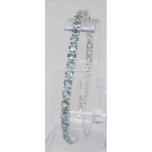 404 - A Blue Topaz Gemstone Tennis Bracelet set in 925 Silver. 19cm.