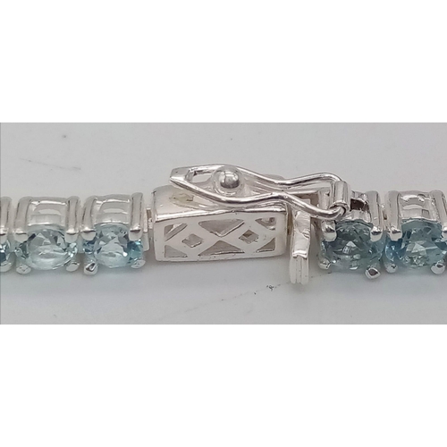 404 - A Blue Topaz Gemstone Tennis Bracelet set in 925 Silver. 19cm.