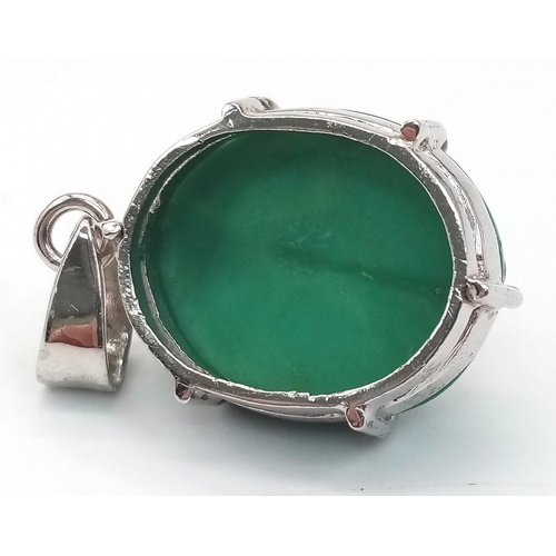 571 - An Oval Turquoise Cabochon Pendant. Set in 925 Sterling Silver. 7.80g. 4cm