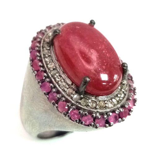 60 - An 11.45cts Cabochon Ruby Ring with .45ct Diamond and 1.25ct Ruby halos. Set in 925 silver. Size N. ... 