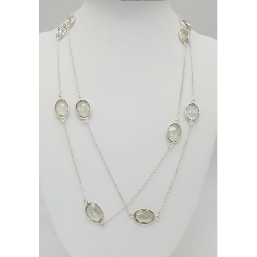 677 - A Green Amethyst Rope- Length Chain. Oval faceted amethysts set in 925 Sterling Silver. 48cwt.