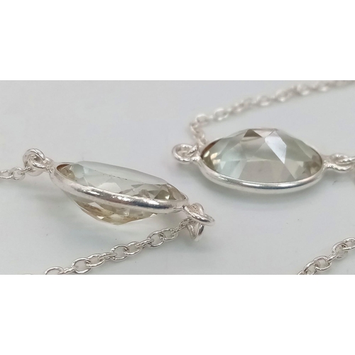 677 - A Green Amethyst Rope- Length Chain. Oval faceted amethysts set in 925 Sterling Silver. 48cwt.