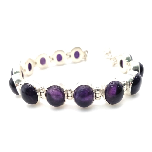 549 - A Brazilian Amethyst Tennis Bracelet. Oval cut amethysts set in 925 Sterling Silver. 66ctw. 28.7g to... 