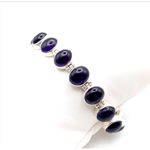 549 - A Brazilian Amethyst Tennis Bracelet. Oval cut amethysts set in 925 Sterling Silver. 66ctw. 28.7g to... 