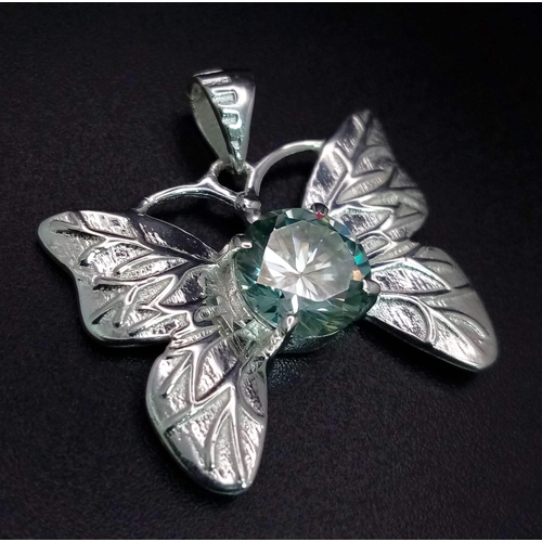 655 - A 2ct Blue Moissanite Butterfly Pendant set in 925 Silver. 25mm - comes with a GLI certificate.