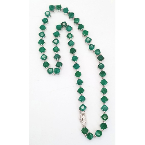 683 - An Emerald Gemstone Tennis necklace - Set in 925 Silver.
50 cushion cut emeralds. 35.27g total weigh... 