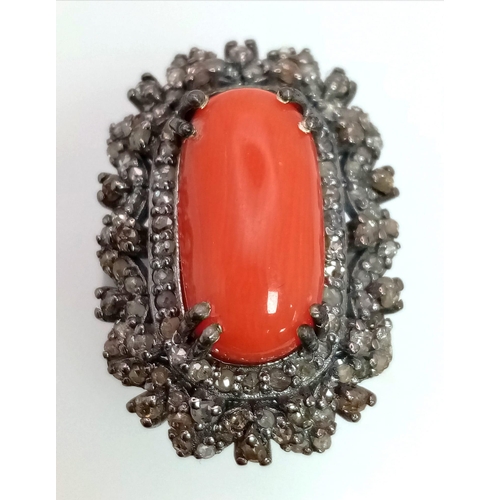 76 - A 5.20ct Red Coral Ring with 1.35ct of Diamond Accents. Set in 925 Silver. Size L. Comes with a GLI ... 