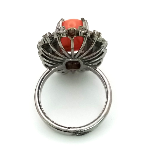 76 - A 5.20ct Red Coral Ring with 1.35ct of Diamond Accents. Set in 925 Silver. Size L. Comes with a GLI ... 