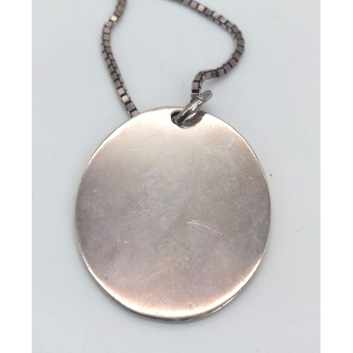 825 - A sterling silver chain necklace with a large round flat pendant carrying oversized British hallmark... 