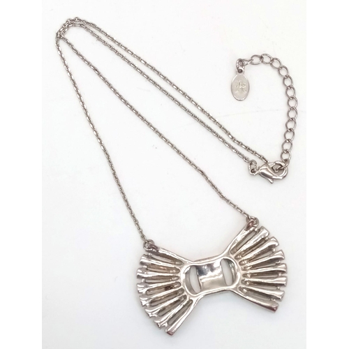 832 - An elegant and sophisticated starling silver chain necklace with a bow pendant loaded with Austrian ... 