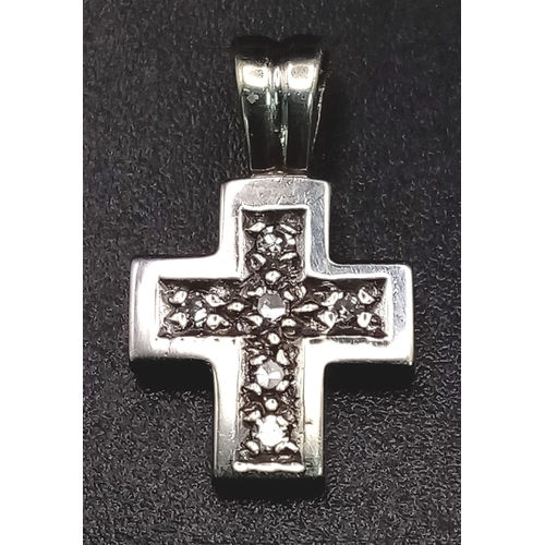 834 - A Miniature White Gold and Diamond Cross Pendant. 18mm
1.44g total weight.